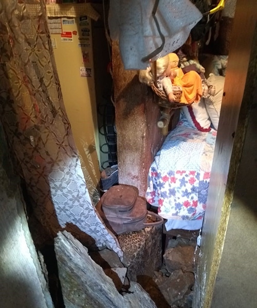 Parede de casa desaba e mulher fica presa nos escombros